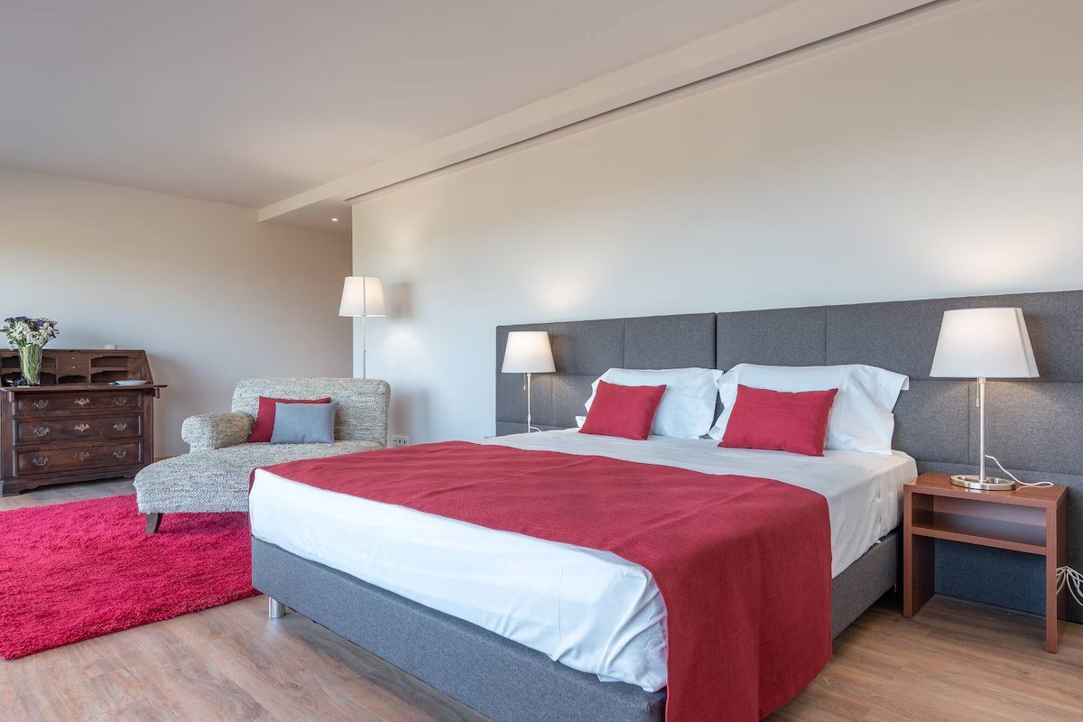 Bedroom at Algarve Esencial with a wood-toned headboard
