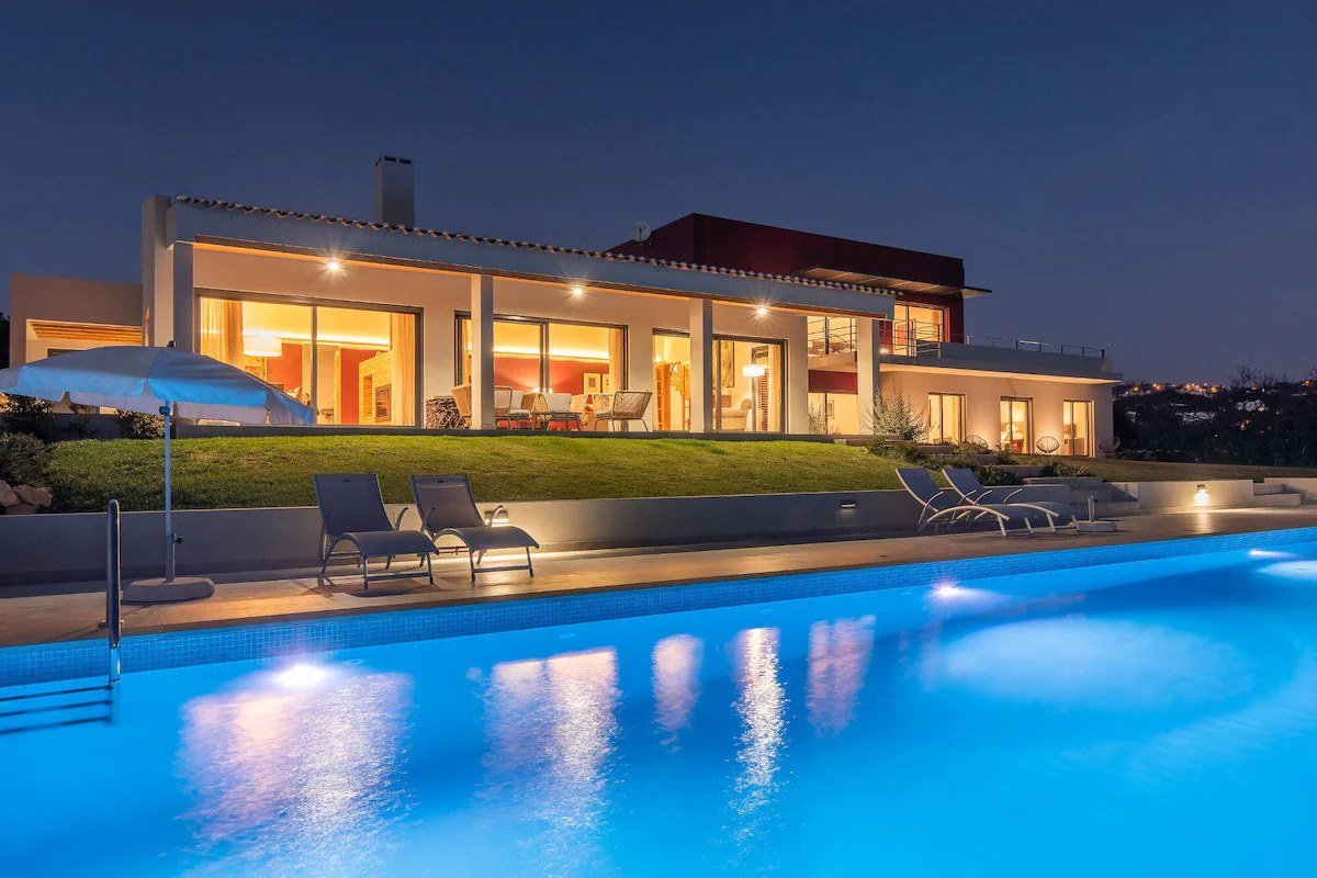 Algarve Esencial villa at night, with its pool illuminated