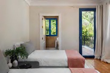 Twin bedroom at Villa Lentisco opening onto a private terrace