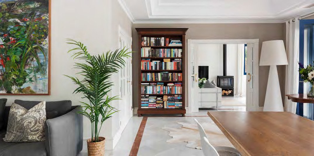 Library nook at Villa Lentisco, with a marble floor and terracotta trim