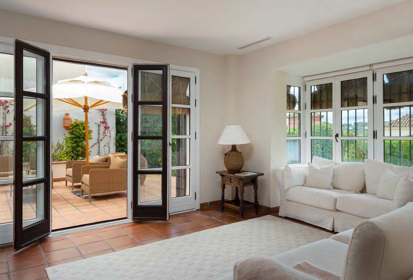 Living room at Cortijo Lirio de Noche, opening onto a shaded terrace